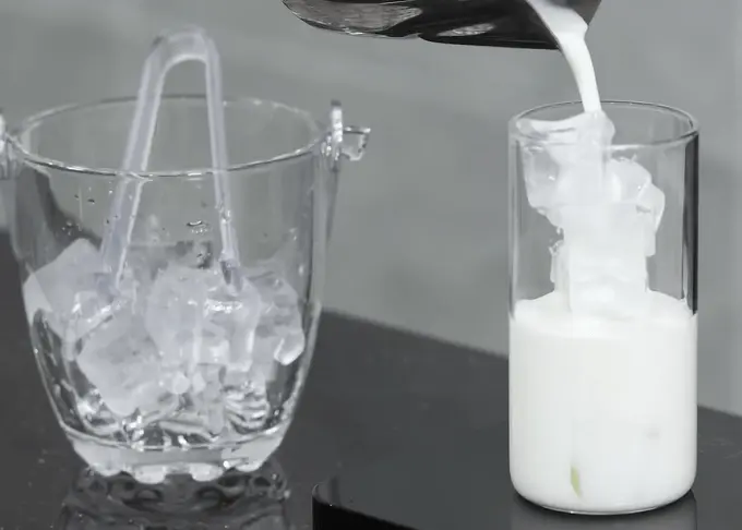 Add milk into iced vanilla latte cup